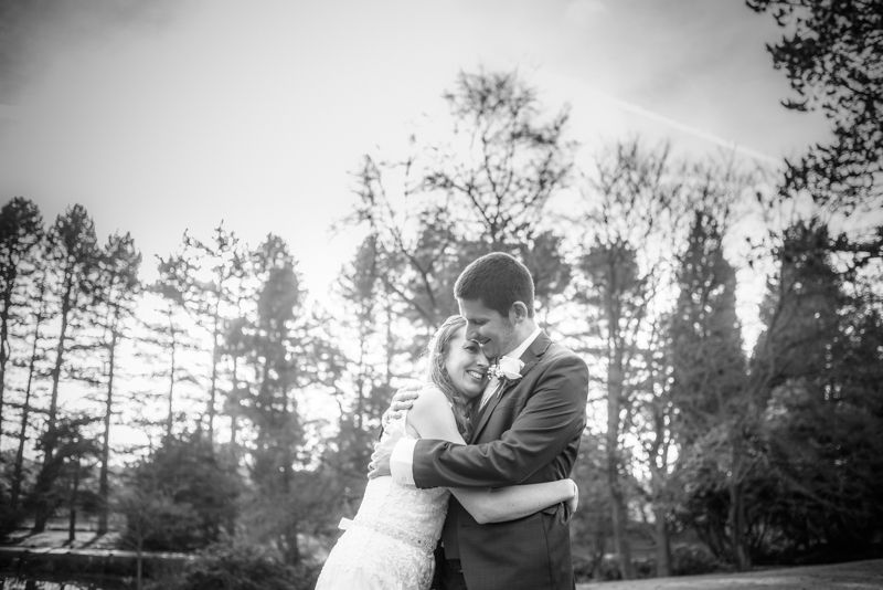 Cuddles for bride and groom Sheffield wedding photographers Whirlowbrook Hall