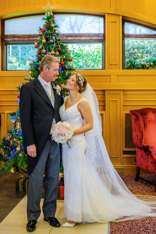 Amanda and her Dad by Christmas tree Hellaby Hall wedding photographers Rotherham