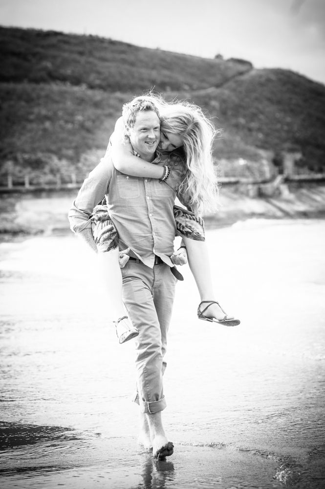 Piggy back on beach, engagement photos Tynemouth