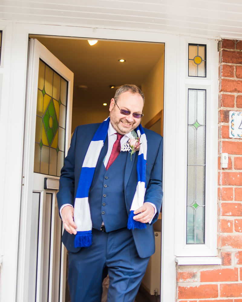 Dad leaving house with football scarf, Maynard wedding, Sheffield photographers