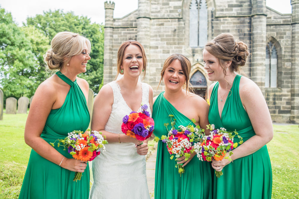Sheffield wedding photographers, Bridal party laughing outside church in Stannington