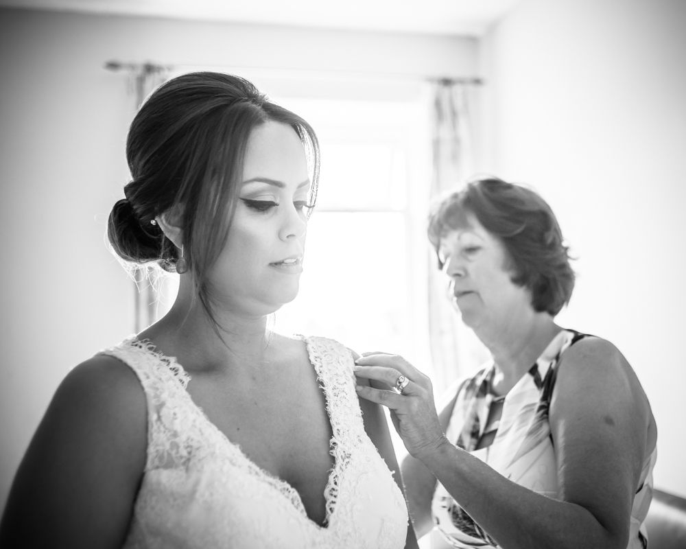 Sheffield wedding photographers, bride getting into dress