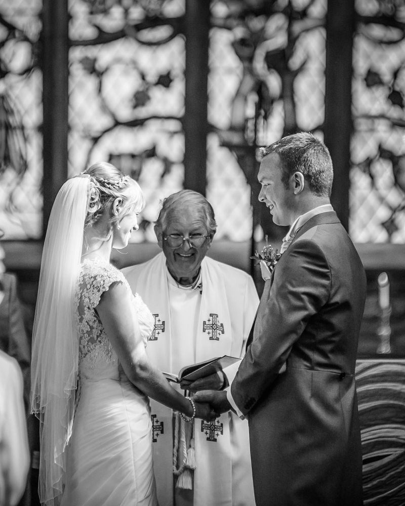 Exchanging vows in church, Sheffield wedding photographers, Smallshaw Farm Cottages