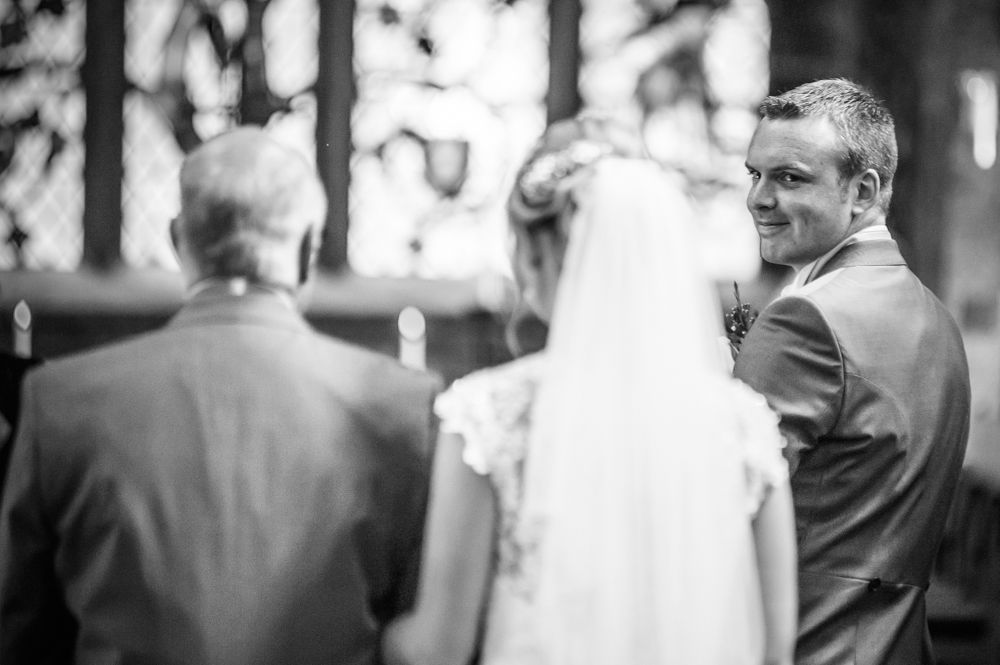 Groom seeing bride walking up aisle, Sheffield wedding photographers, Smallshaw Farm Cottages