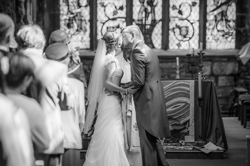 Bride and groom first kiss, Sheffield wedding photographers, Smallshaw Farm Cottages