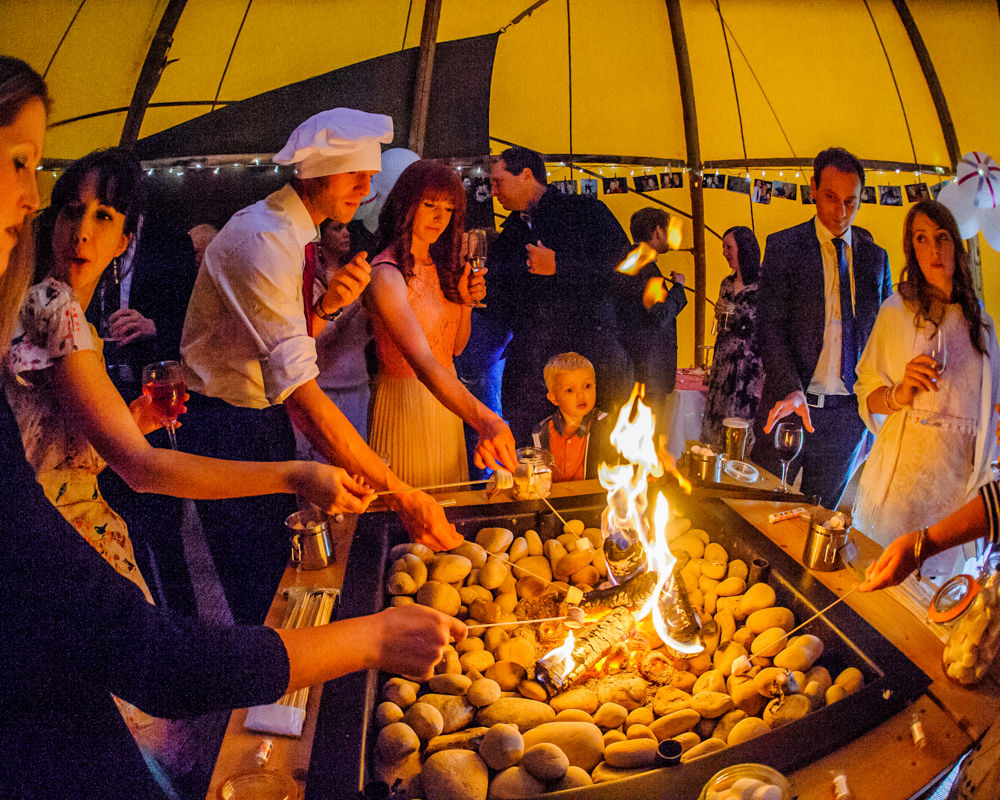 Toasting marshmallows. Sheffield wedding photographers, Smallshaw Farm Cottages