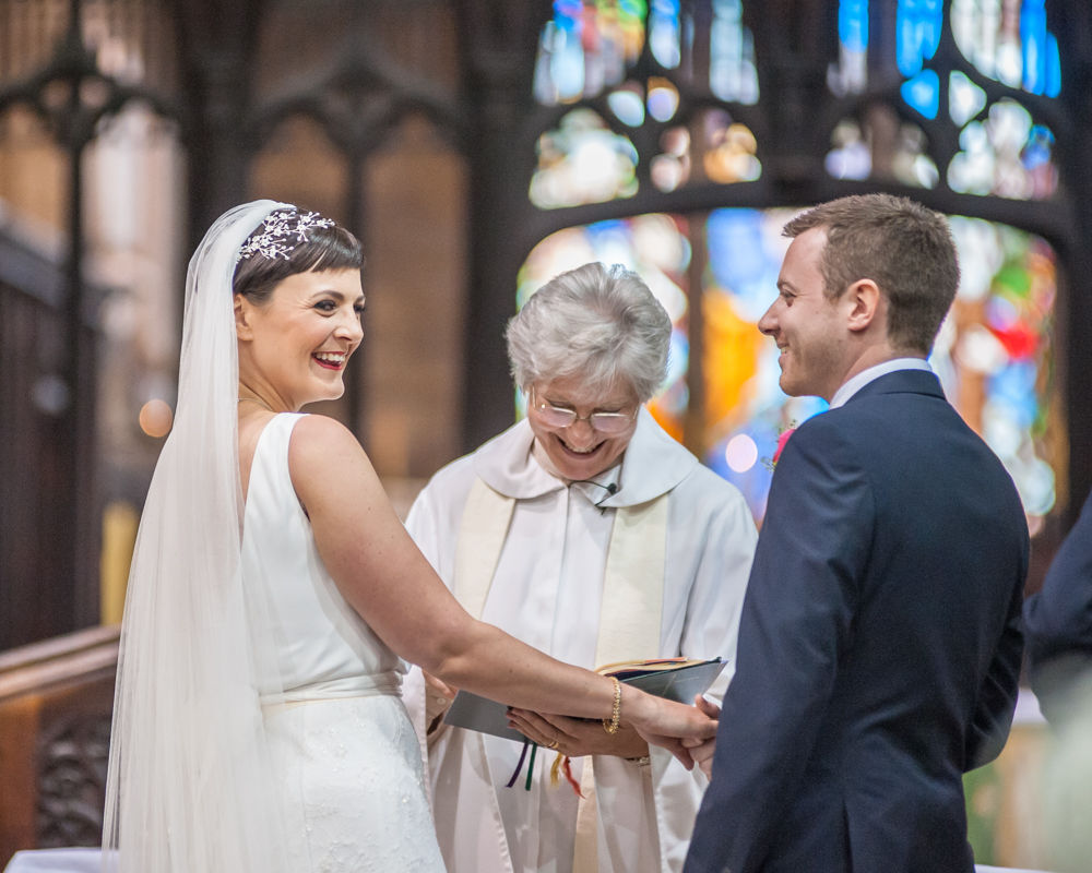 Bride laughing in ceremony, St Mary's Ecclesfield, Sheffield
