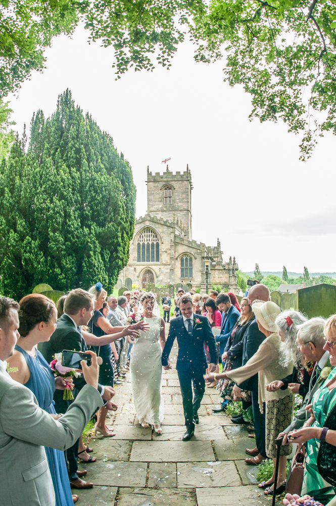Bride and groom walking away from St Mary's Church Ecclesfield, Sheffield