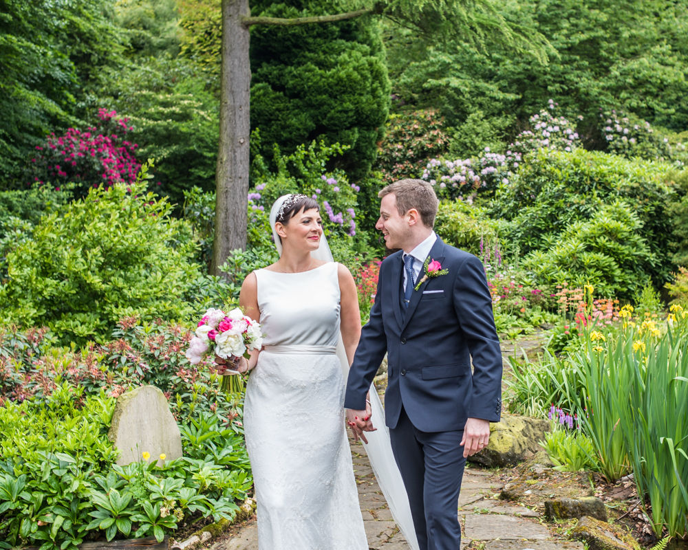 Bride and groom walking in grounds, Sheffield wedding photographers, Whirlowbrook Hall