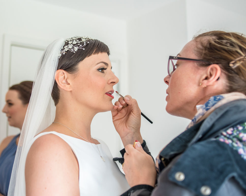 Bride getting lipstick finished, Sheffield wedding photographer