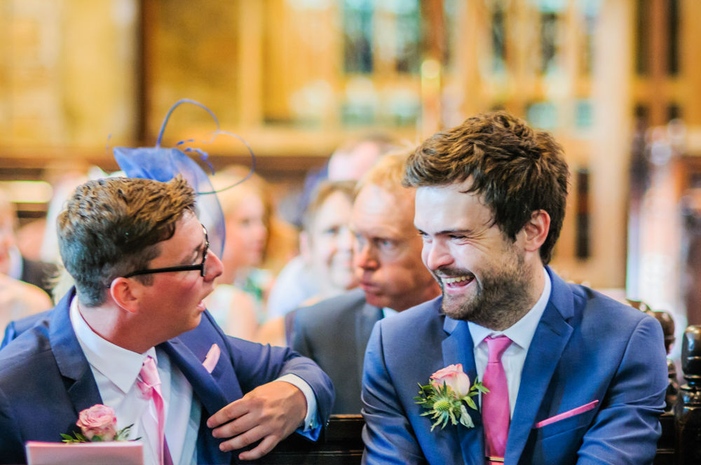 Groom and best man laughing in church, Barnsley wedding photographers