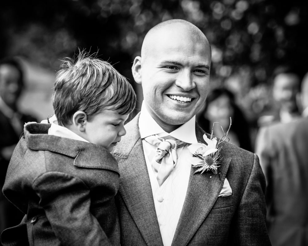 Groom with son walking to church, Sheffield wedding photographers