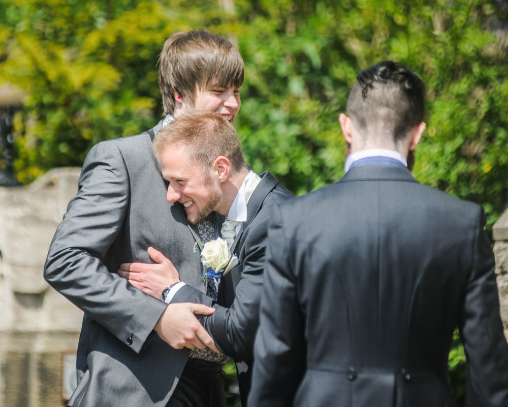 Groom and best man laughing, Sheffield wedding photographers