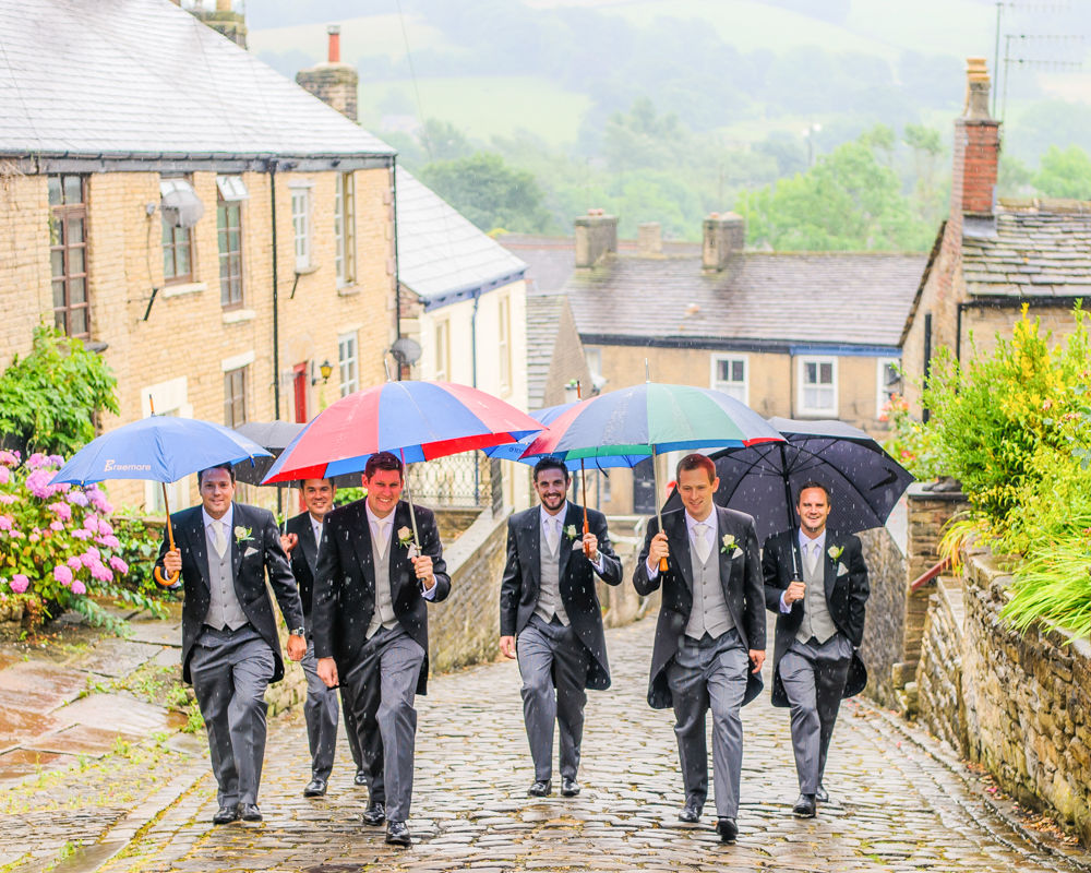 Groomsmen walking to church in rain, Peak District wedding photographers