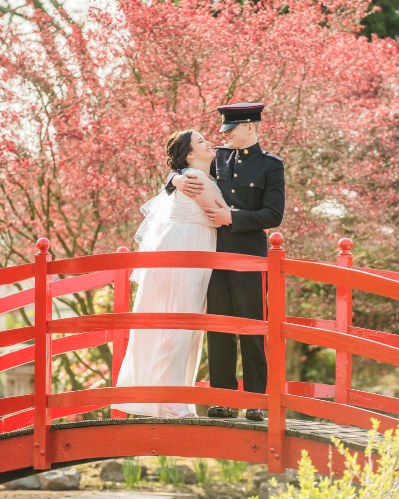 Bride and groom on bridge in water gardens, Greens at Gretna wedding