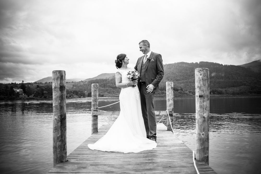 Laughing on the jetty on Derwent, Lingholm wedding, Lake District