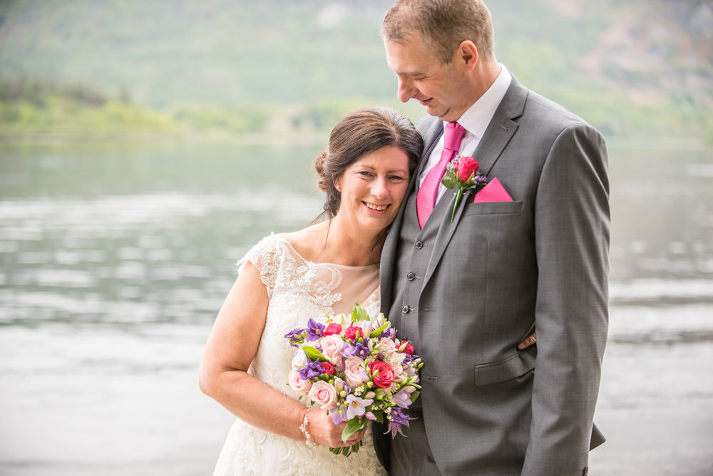 Cuddling up by lake, Lingholm wedding, Lake District