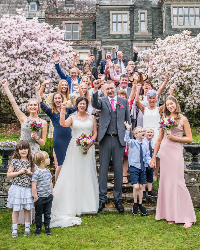 Full group photo waving, Lingholm wedding, Lake District