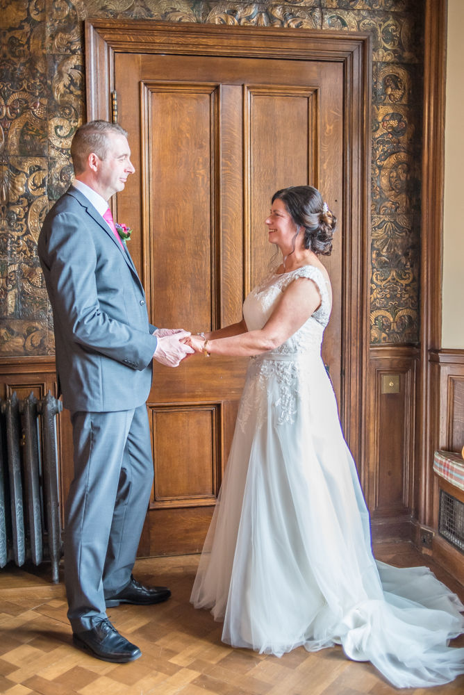 Holding hands in ceremony, Lingholm wedding, Lake District