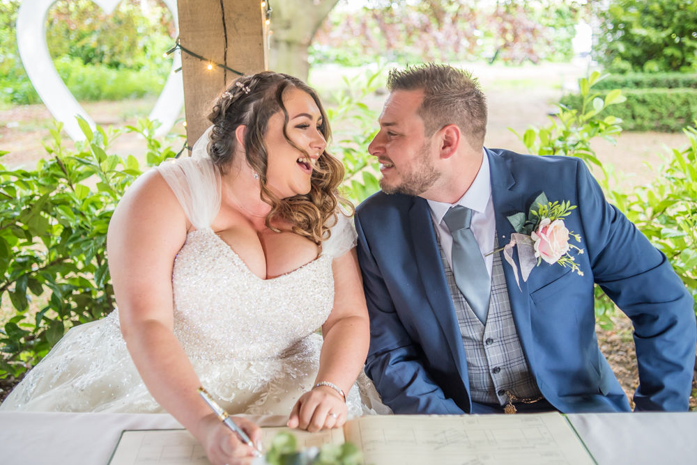 Laughing during register signing, Ye Olde Bell wedding, Retford