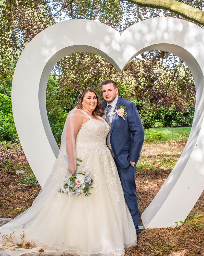 Bride and groom outside large heart, Ye Olde Bell wedding, Retford
