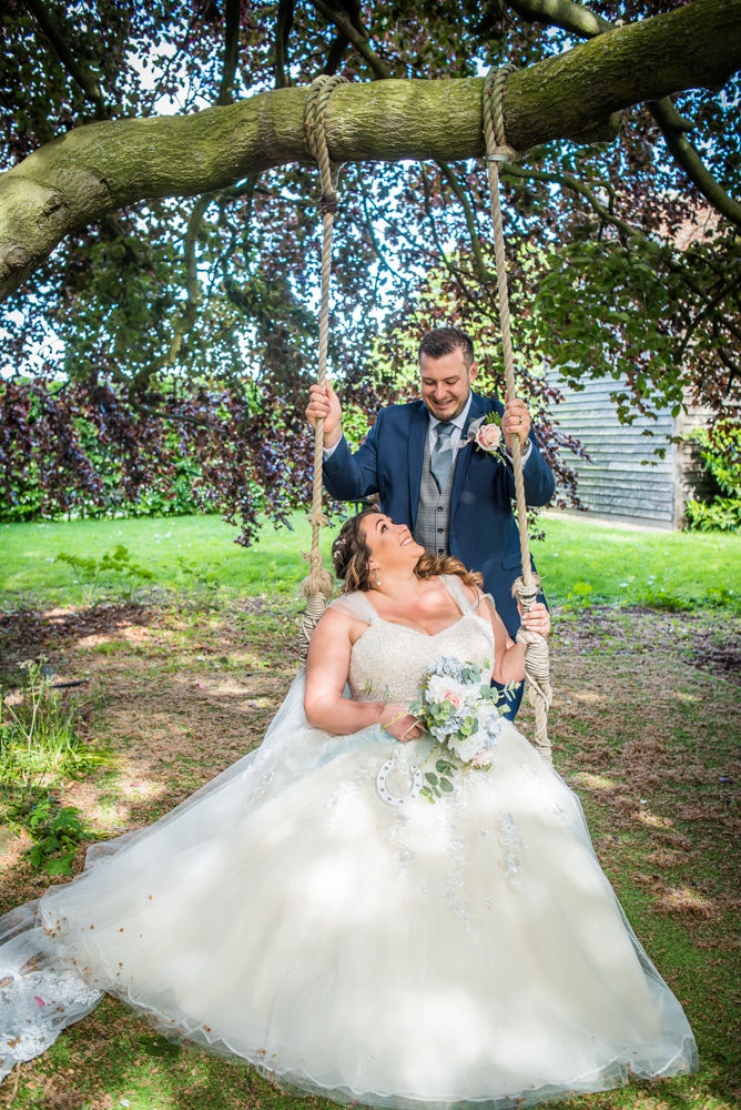 Bride and groom on swing, Ye Olde Bell wedding, Retford