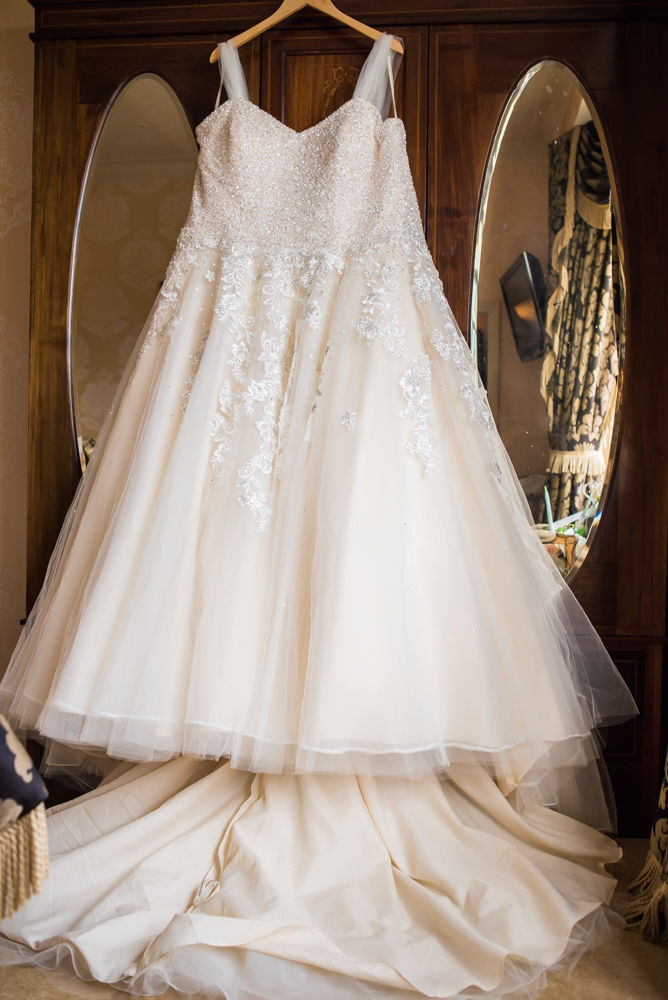 Alex's wedding dress hanging up in Ye Olde Bell bridal suite