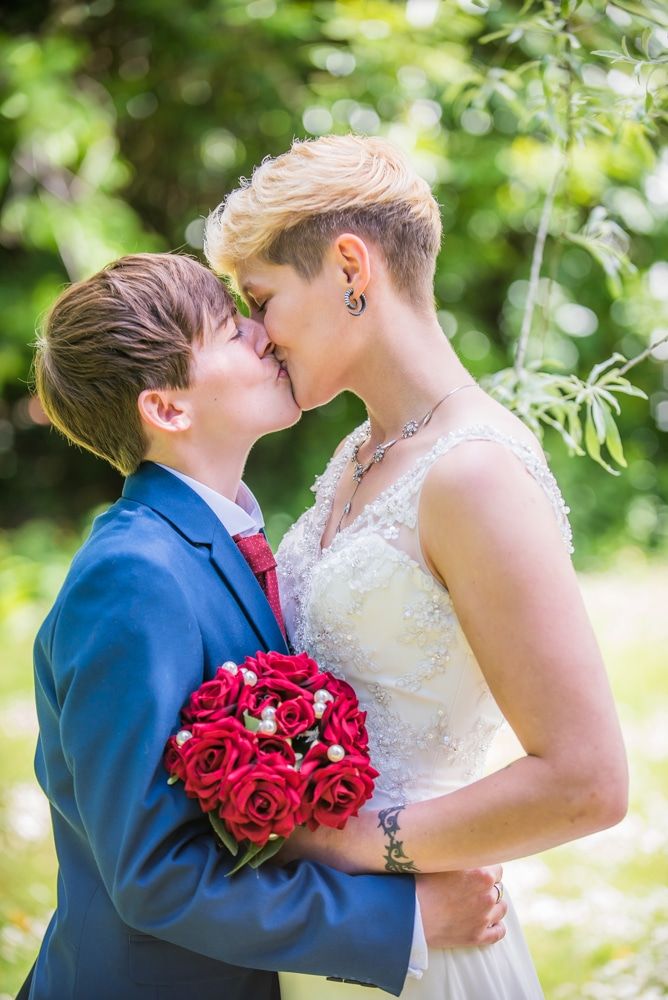 Kissing in the grounds, Carlisle Register office, Lake District wedding photography