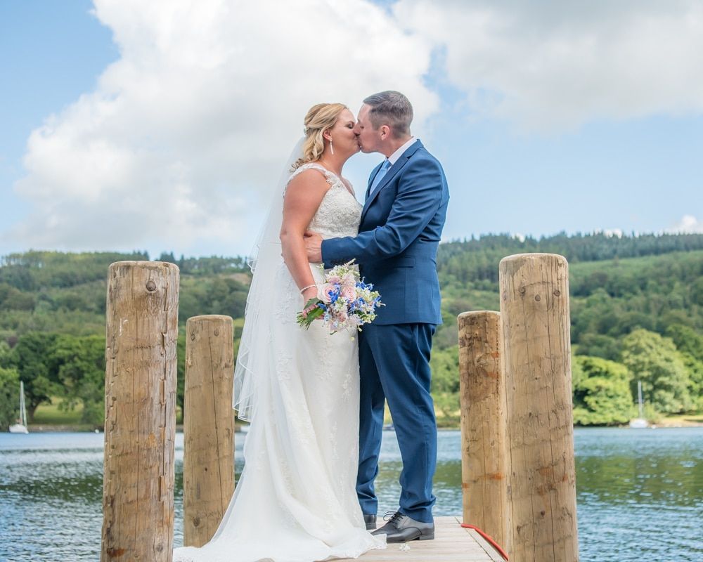 Bride and groom on the lake jetty at Windermere