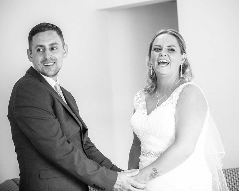 Bride and groom laughing, Lakeside Hotel weddings, Windermere