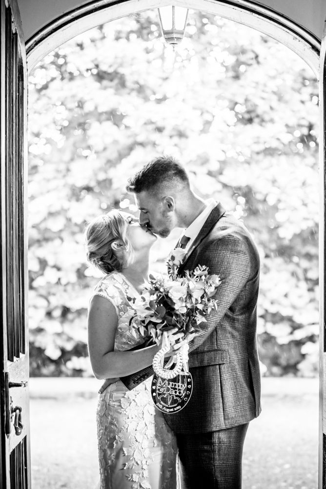 Kisses in doorway,  wedding photographers Carlisle register office elopement wedding Lake District