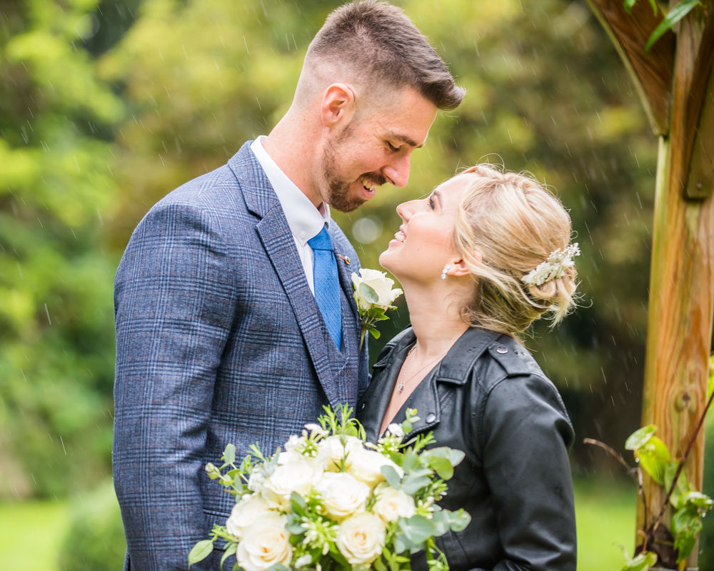 Loving looks in the rain,  wedding photographers Carlisle register office elopement wedding Lake District
