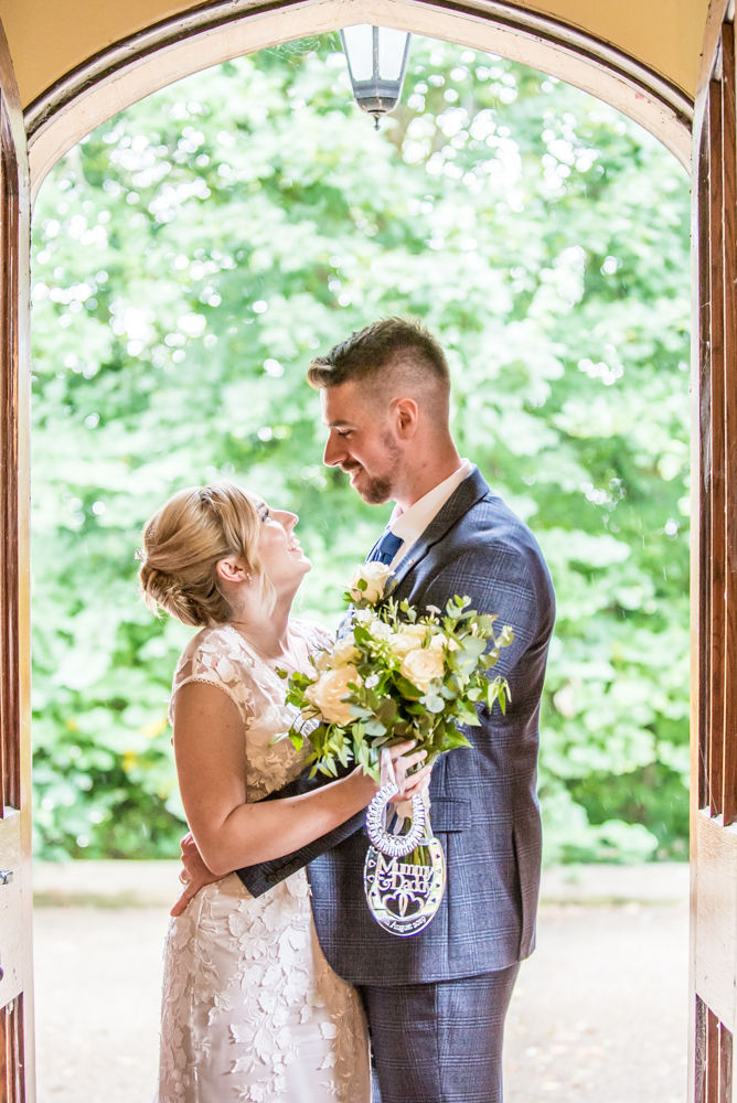 Bride and groom in doorway,  wedding photographers Carlisle register office elopement wedding Lake District