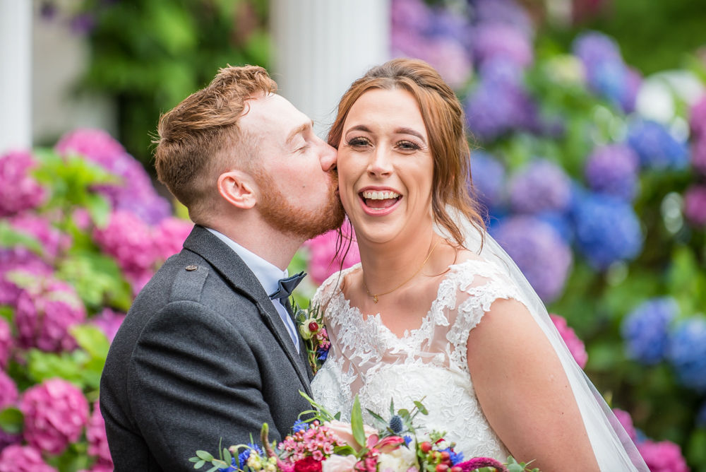 Kissing his new wife, laughter, Sheffield wedding photographers, Ringwood Hall Hotel