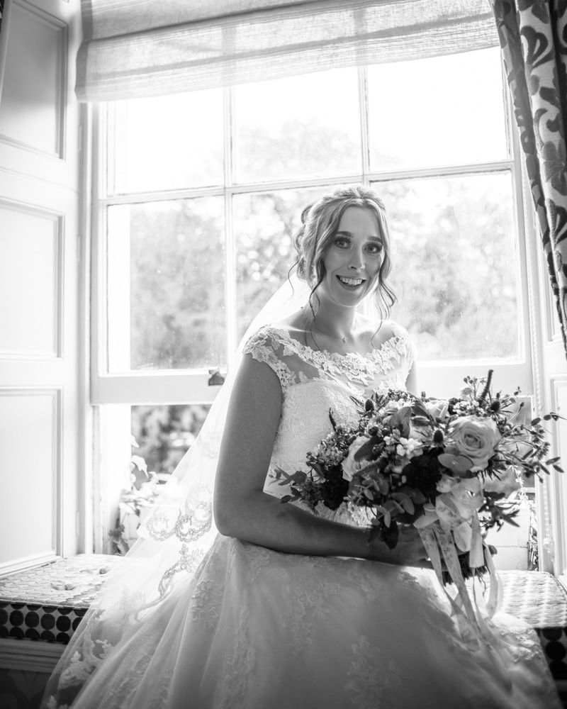 Bride posing in window seat before wedding, Sheffield wedding photographers, Ringwood Hall Hotel