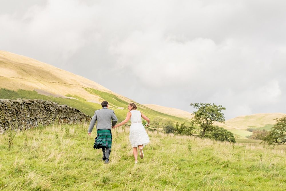 Running through the fields, Howgills wedding, Sedbergh, Lake District wedding photographers