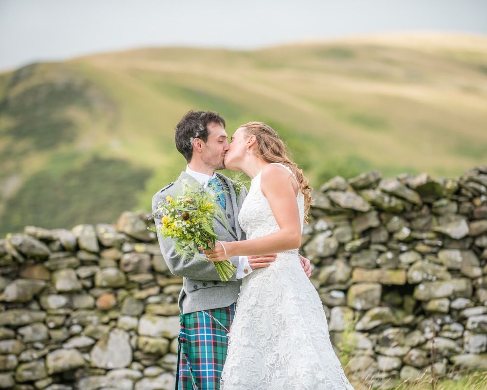 Kisses with fell views, Howgills wedding, Sedbergh, Lake District wedding photographers