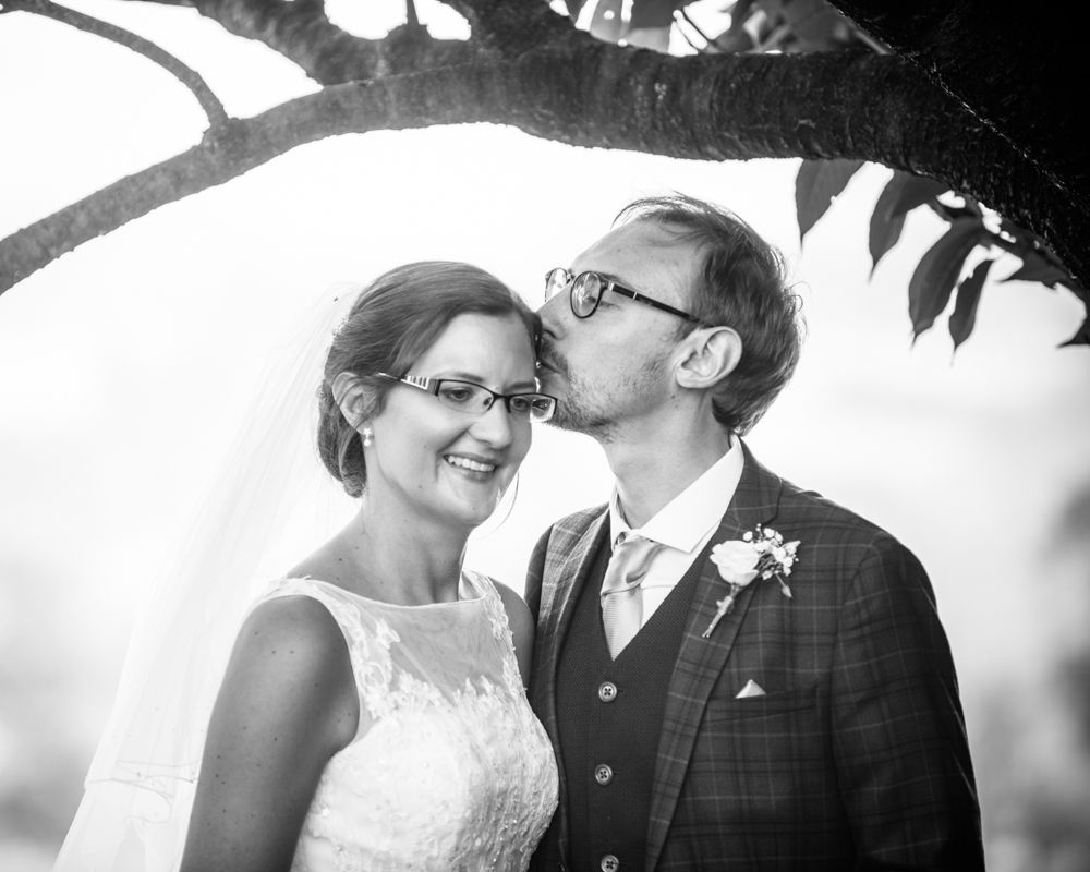 Groom kissing brides head, Shireburn Arms, Lancashire wedding photographers