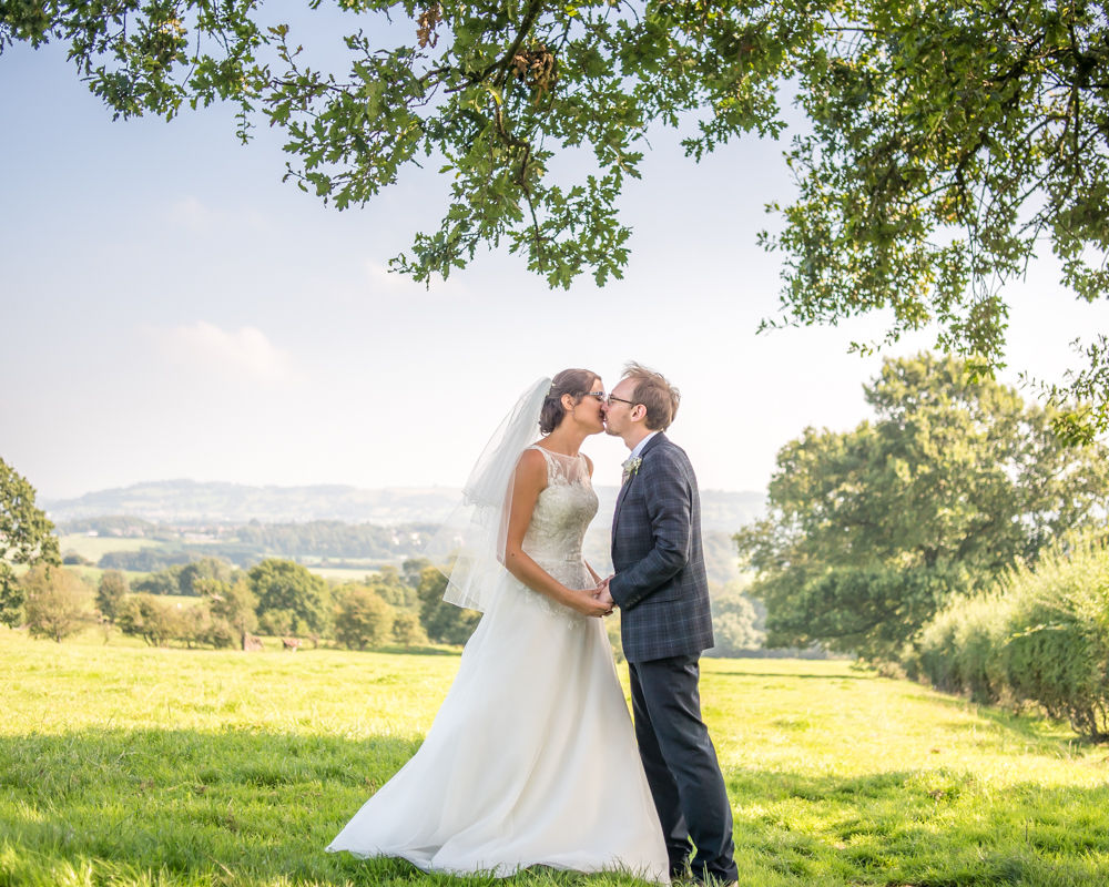 Kissing under tree in the field, Shireburn Arms, Lancashire wedding photographers