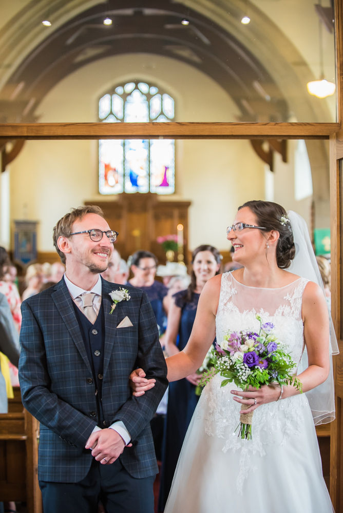 Bride and groom laughing during ceremony, Shireburn Arms, Lancashire wedding photographers