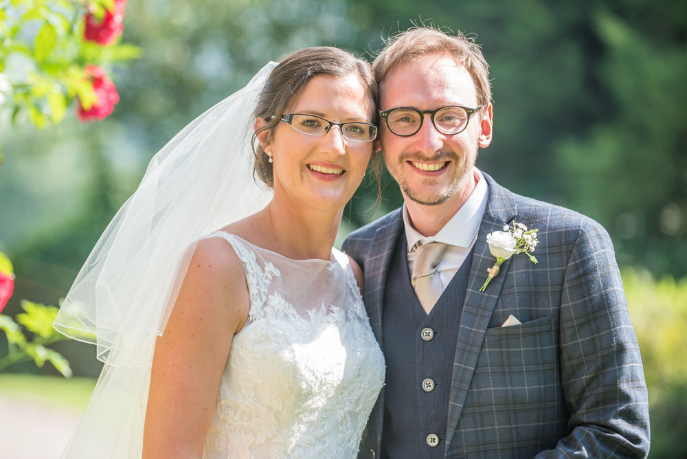 Bride and groom posing in sunshine, Shireburn Arms, Lancashire wedding photographers