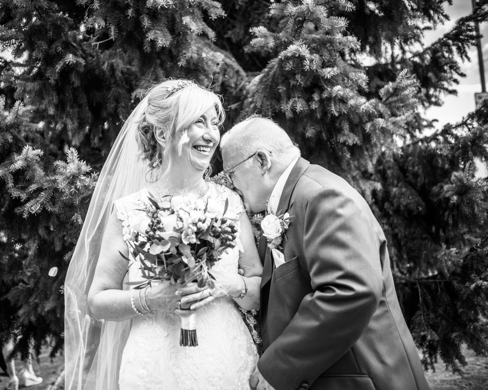 Groom kissing bride's shoulder,  Hotel Van Dyk wedding photography Chesterfield