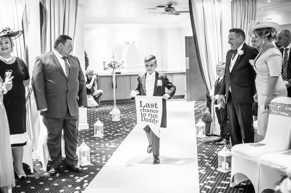 Bride's son walking down aisle with sign, Waterton Park Hotel weddings, Yorkshire wedding photographers