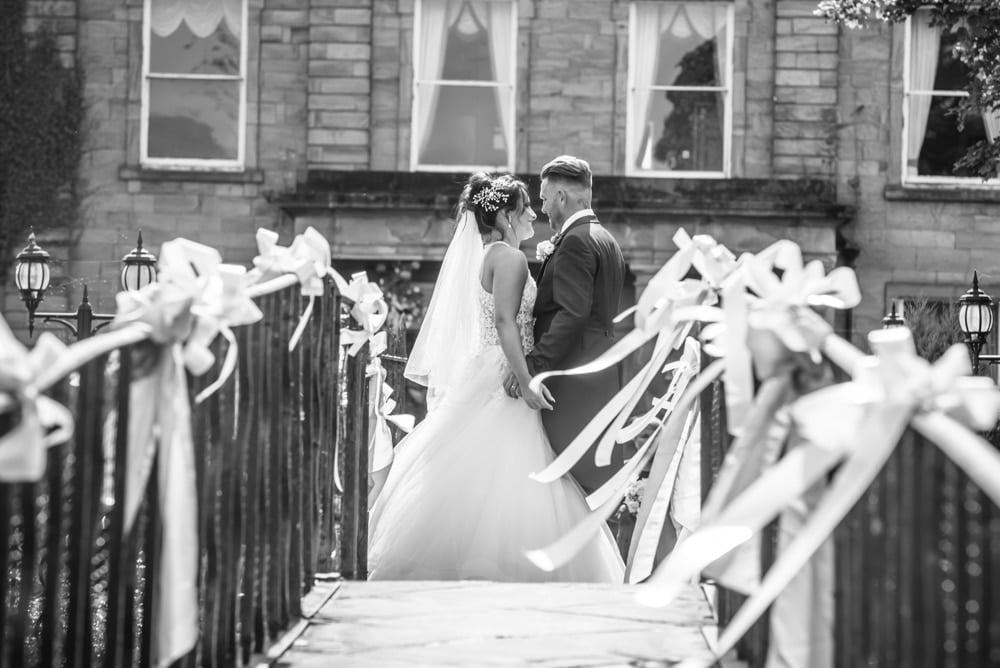 Kisses on the bridge, Waterton Park Hotel weddings, Yorkshire wedding photographers