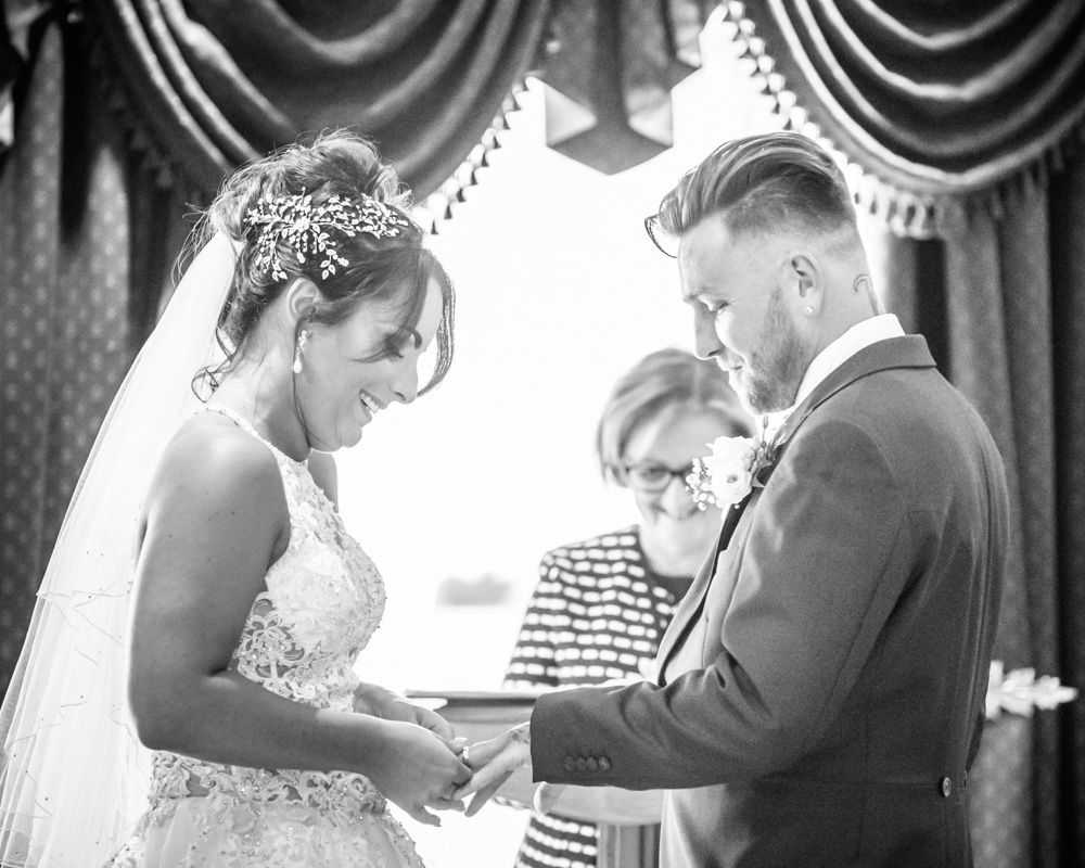 Bride putting ring on groom's finger, Waterton Park Hotel weddings, Yorkshire wedding photographers