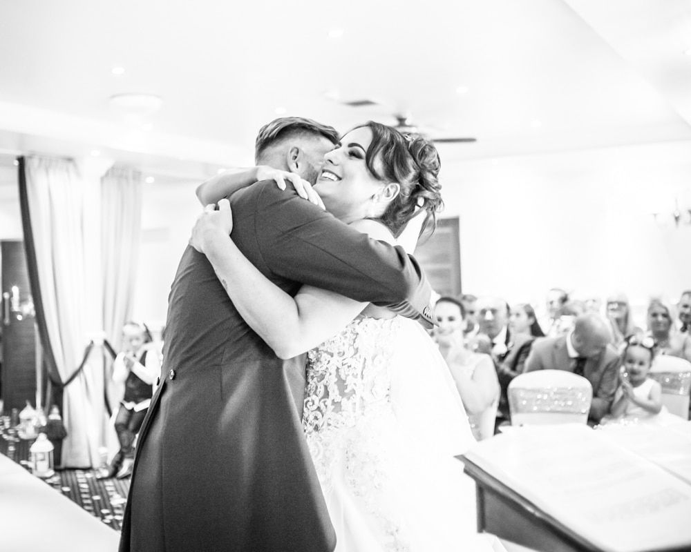 Bride and groom ceremony cuddles, Waterton Park Hotel weddings, Yorkshire wedding photographers