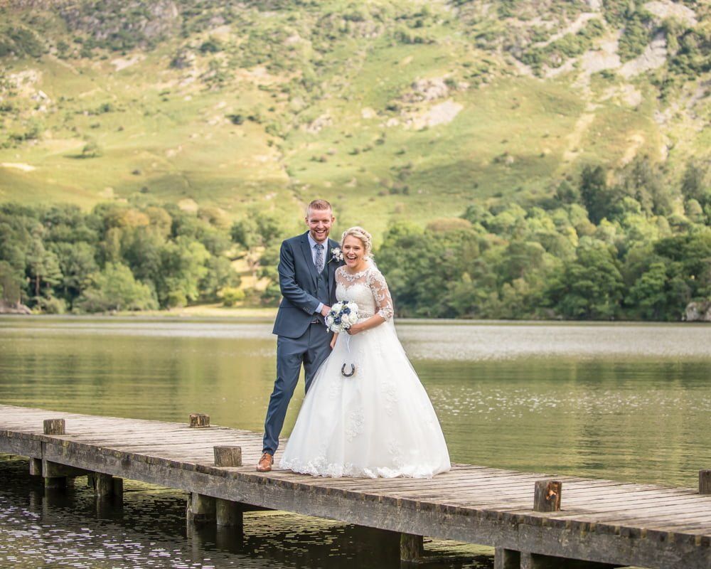 Bride and groom on jetty on Ullswater, Inn on the Lake Weddings, Lake District
