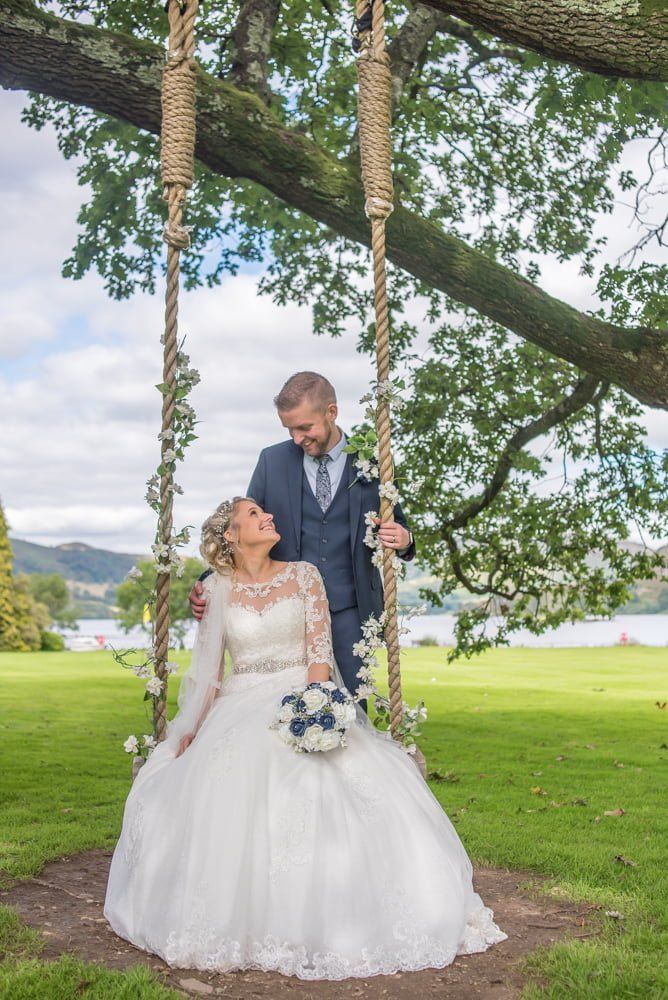 Bride on swing in hotel grounds, Inn on the Lake Weddings, Lake District