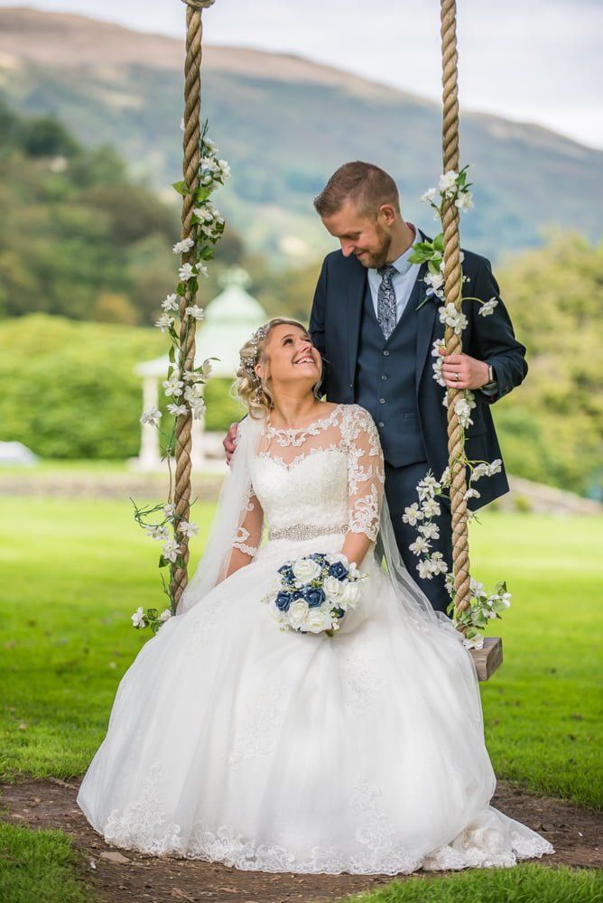 Looking at each other on swing, Inn on the Lake Weddings, Lake District