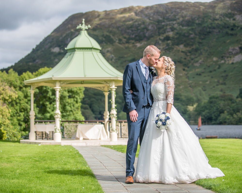 Kissing with pagoda in background, Inn on the Lake Weddings, Lake District